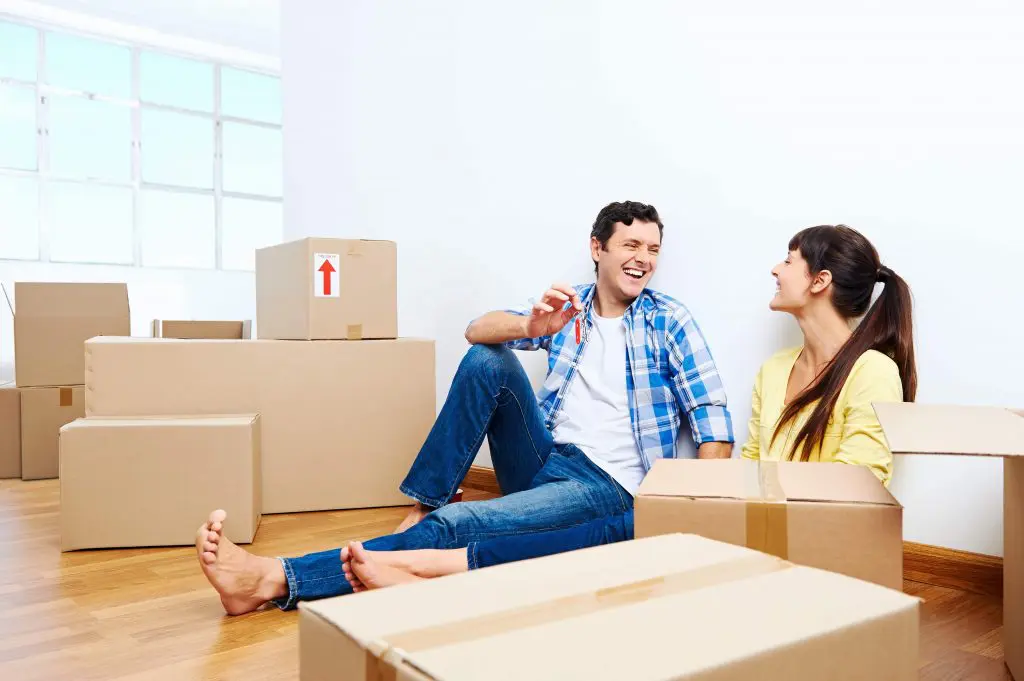 People sat on floor with moving boxes